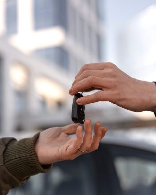 side-view-hands-holding-car-key